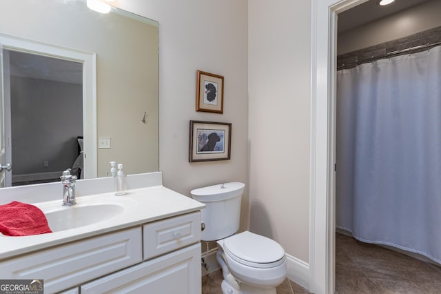 bathroom featuring tile patterned floors, vanity, and toilet