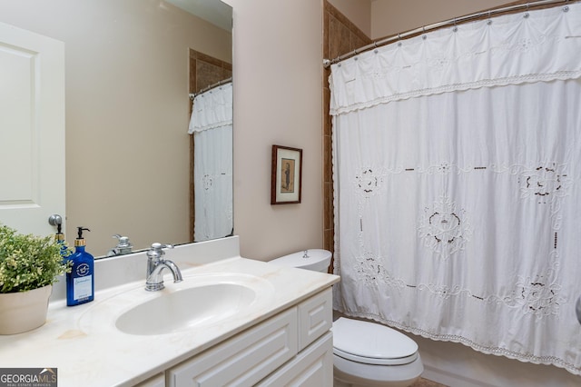 bathroom with toilet, shower / bath combo with shower curtain, and vanity