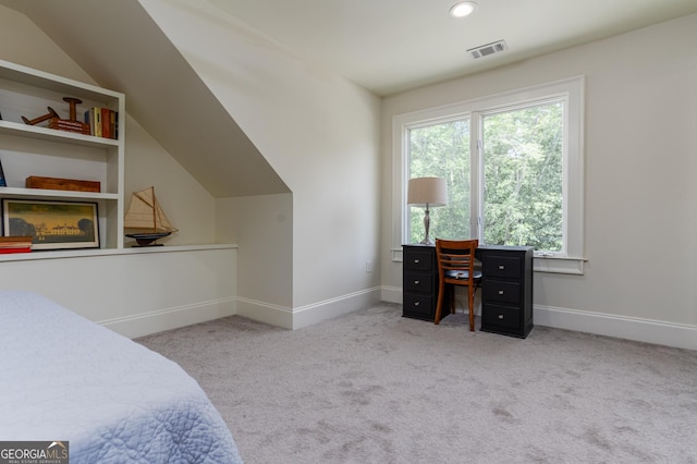 bedroom featuring light colored carpet and lofted ceiling