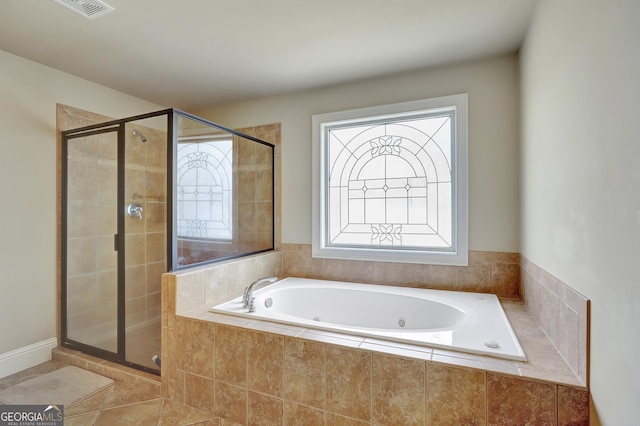 bathroom with independent shower and bath and tile patterned flooring