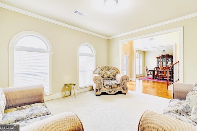 living room with crown molding and light carpet