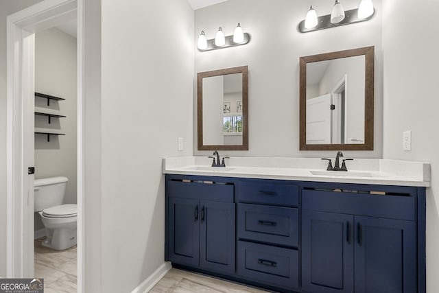 bathroom featuring vanity and toilet