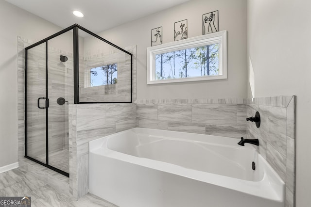 bathroom featuring separate shower and tub