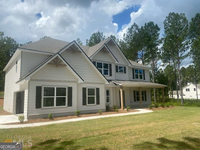 view of front of home featuring a garage, a front lawn, and a porch