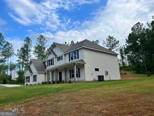 view of front facade featuring central AC and a front lawn