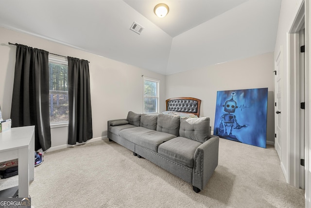 carpeted bedroom with lofted ceiling and multiple windows