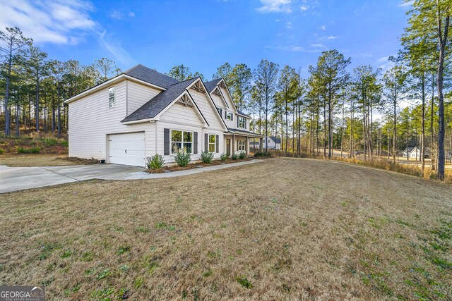 view of home's exterior with a yard and a garage