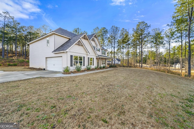 view of side of home featuring a garage and a lawn