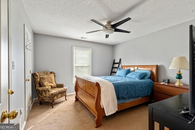 carpeted bedroom featuring a textured ceiling and ceiling fan