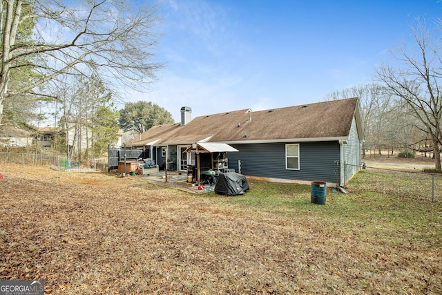 back of property featuring a patio and a yard