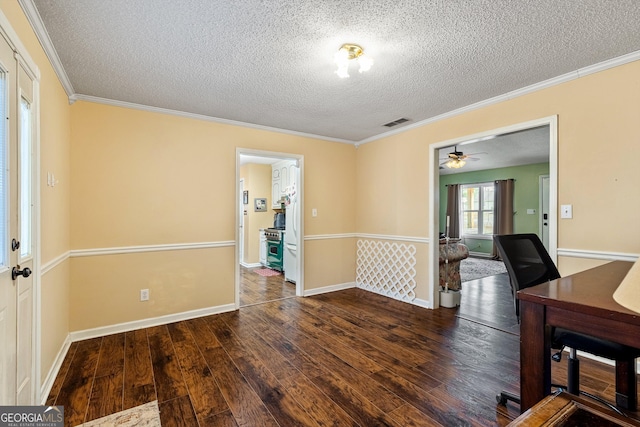 interior space featuring crown molding, dark hardwood / wood-style floors, and a textured ceiling