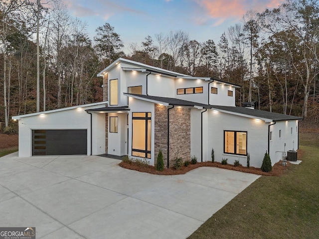 contemporary house with a garage and central air condition unit