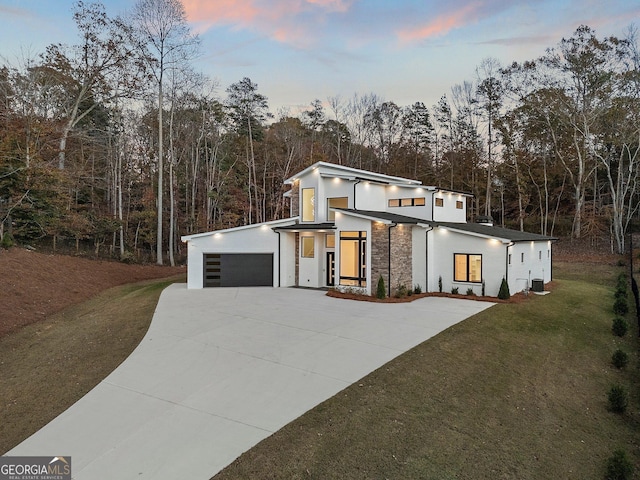 contemporary house with a yard and a garage