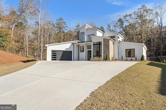 modern home with a garage and a front lawn