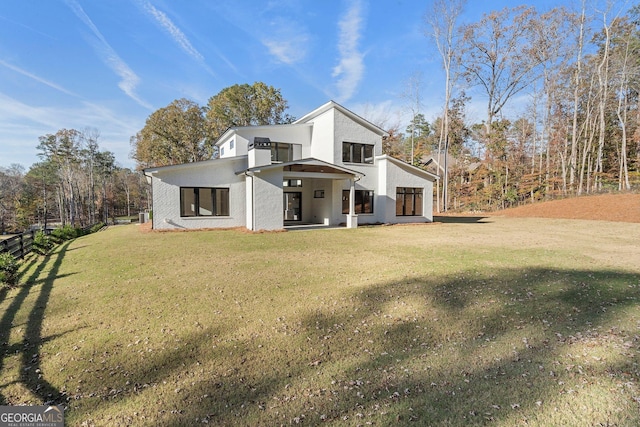 view of side of home with a yard