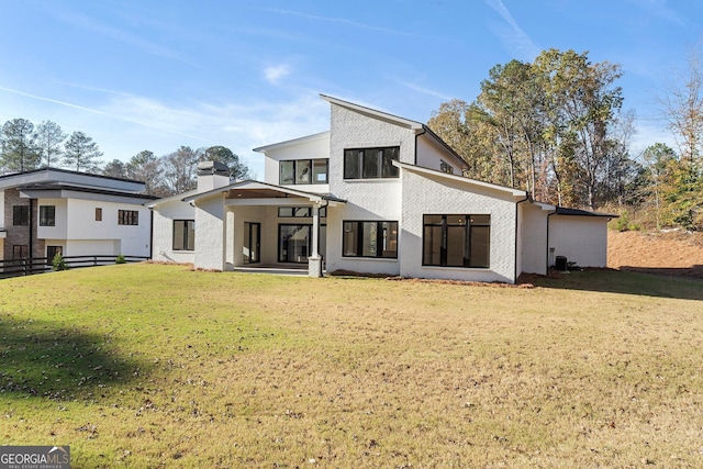 back of property featuring a lawn