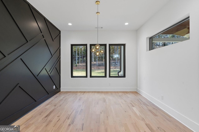 unfurnished dining area featuring light hardwood / wood-style flooring