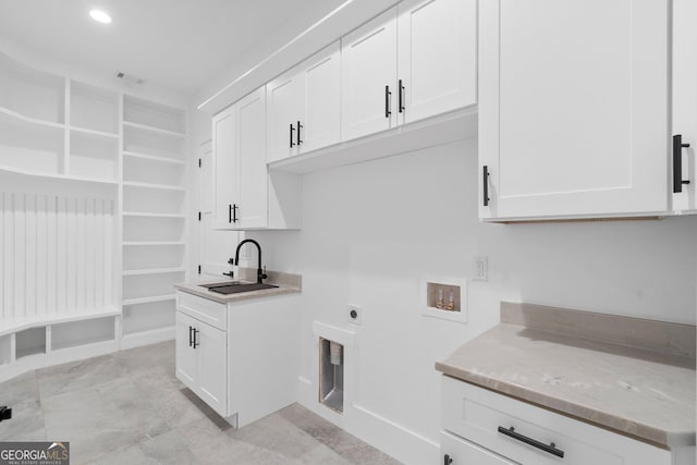 washroom with cabinets, washer hookup, hookup for an electric dryer, and sink