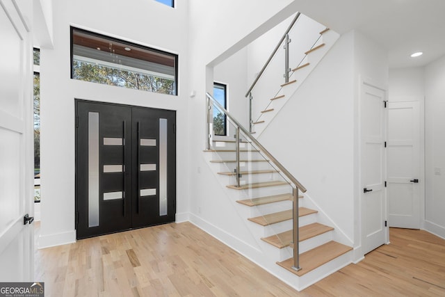 foyer featuring light hardwood / wood-style flooring and a high ceiling