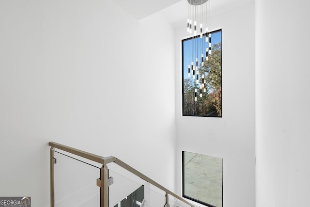 staircase with a chandelier