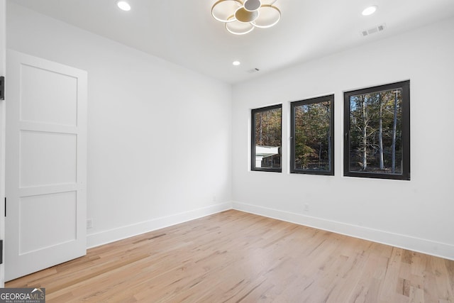 spare room with light hardwood / wood-style floors