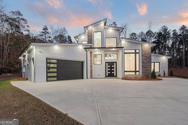 contemporary home featuring a garage and french doors