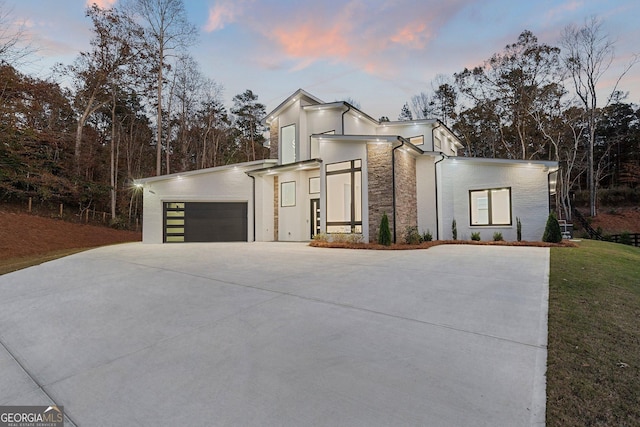 contemporary house with a garage and central AC unit