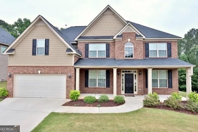 craftsman house with a garage and a front yard