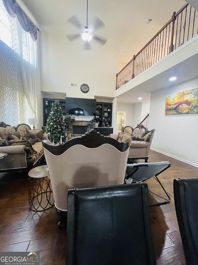 living room featuring a towering ceiling and ceiling fan