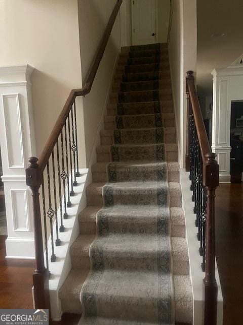 stairway featuring wood-type flooring