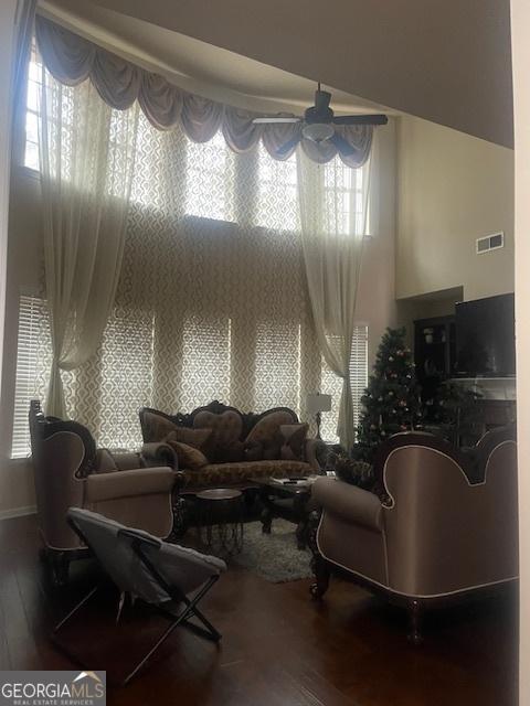 living room featuring hardwood / wood-style flooring and a high ceiling