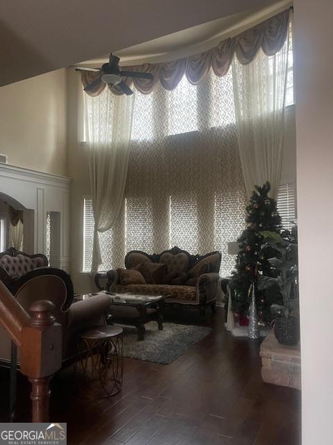 living room featuring hardwood / wood-style floors and a high ceiling