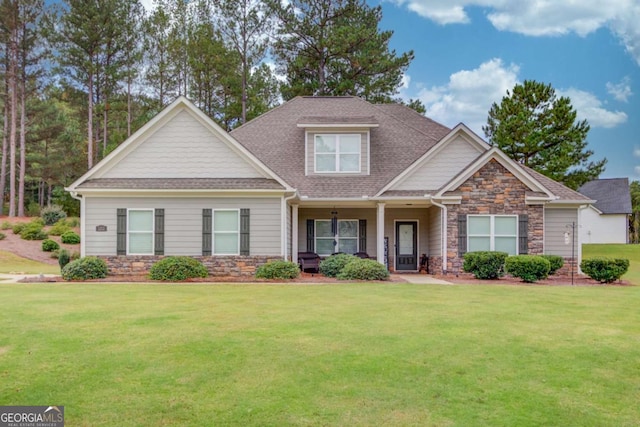 craftsman inspired home with a front lawn