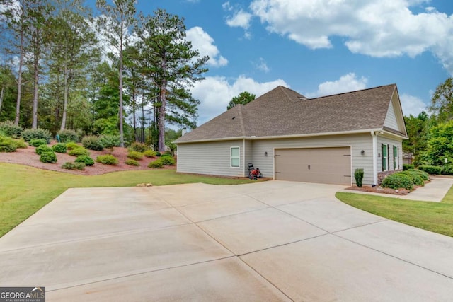 view of home's exterior with a garage and a lawn