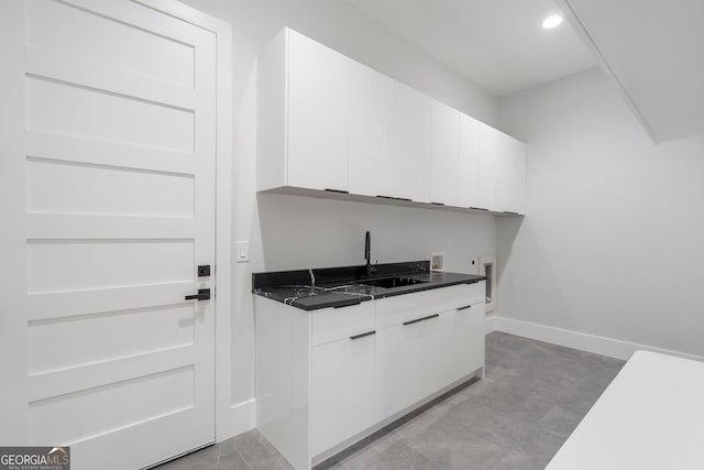 interior space featuring sink and white cabinets