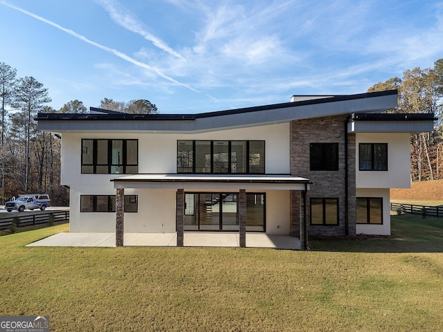 rear view of property with a patio area and a lawn