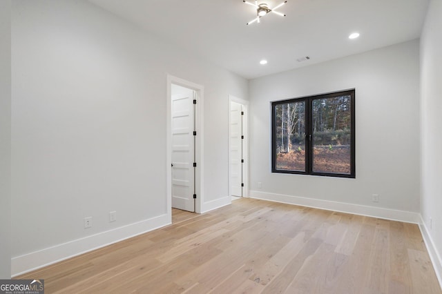 unfurnished room with light hardwood / wood-style flooring