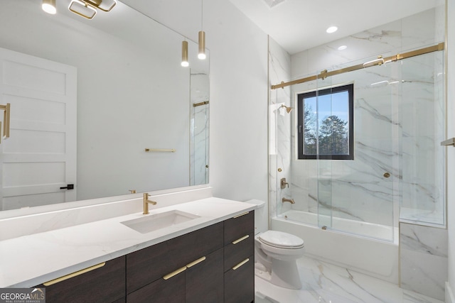 full bathroom featuring enclosed tub / shower combo, vanity, and toilet