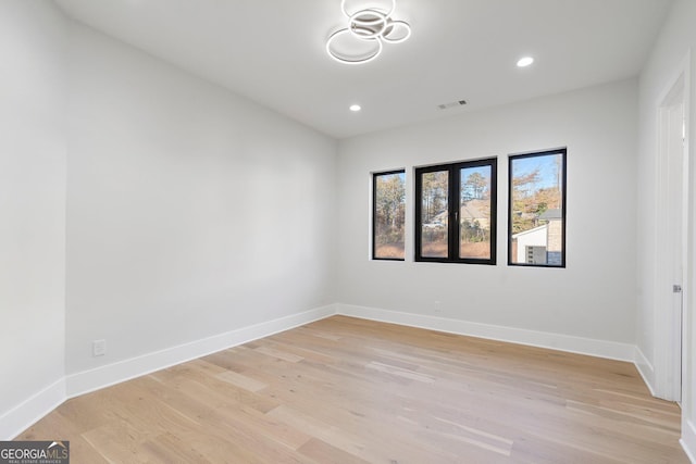 unfurnished room with light hardwood / wood-style floors