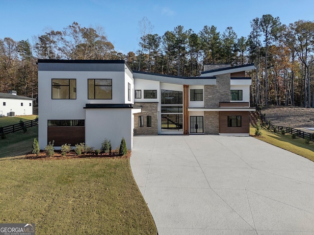 contemporary home featuring a front lawn