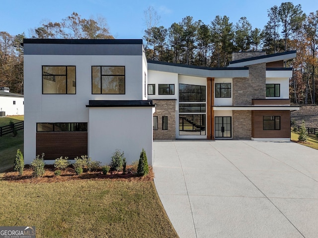 modern home with a front lawn