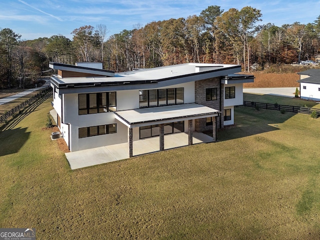 rear view of house featuring a yard and a patio area