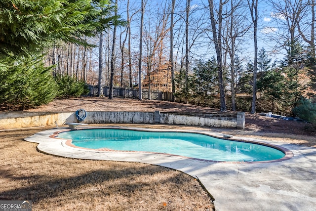 view of swimming pool with a diving board