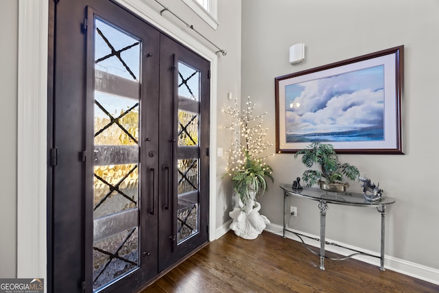 foyer entrance with dark hardwood / wood-style flooring and french doors