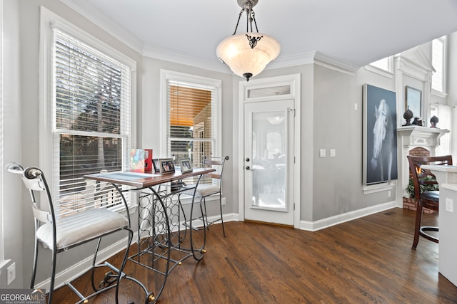 dining area with ornamental molding and dark hardwood / wood-style floors