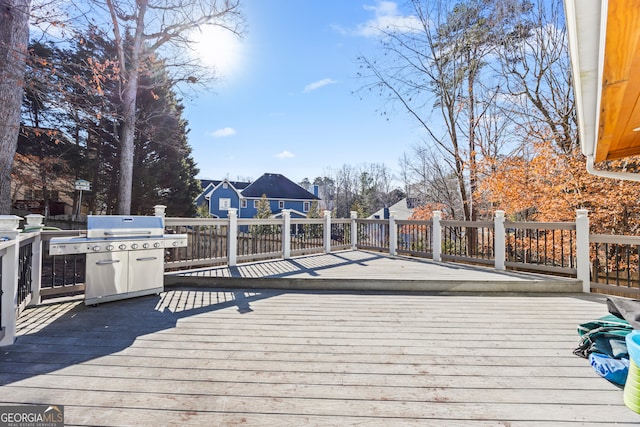 wooden terrace featuring area for grilling