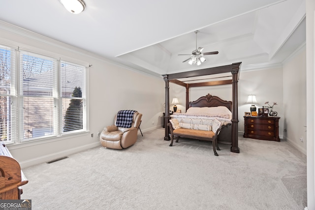 carpeted bedroom featuring multiple windows, crown molding, and a tray ceiling