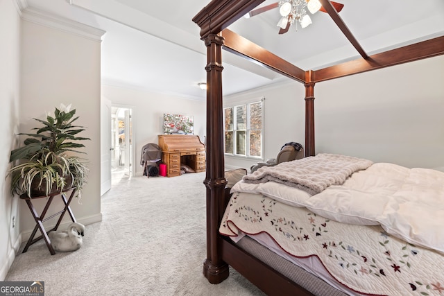 carpeted bedroom with ceiling fan, crown molding, and beamed ceiling