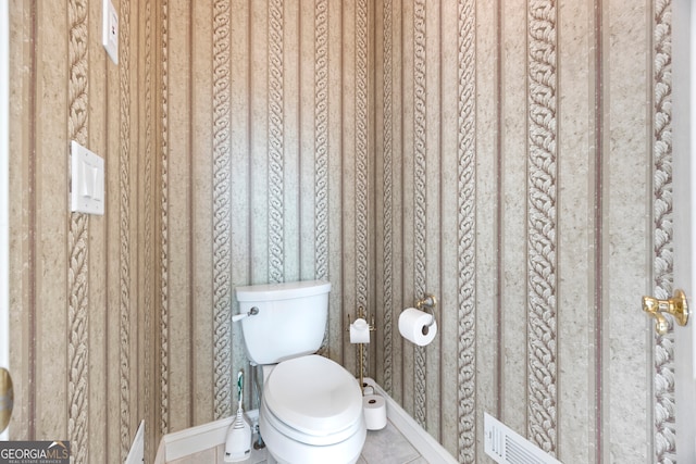 bathroom with tile patterned flooring and toilet