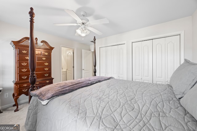 bedroom featuring multiple closets, light colored carpet, and ceiling fan